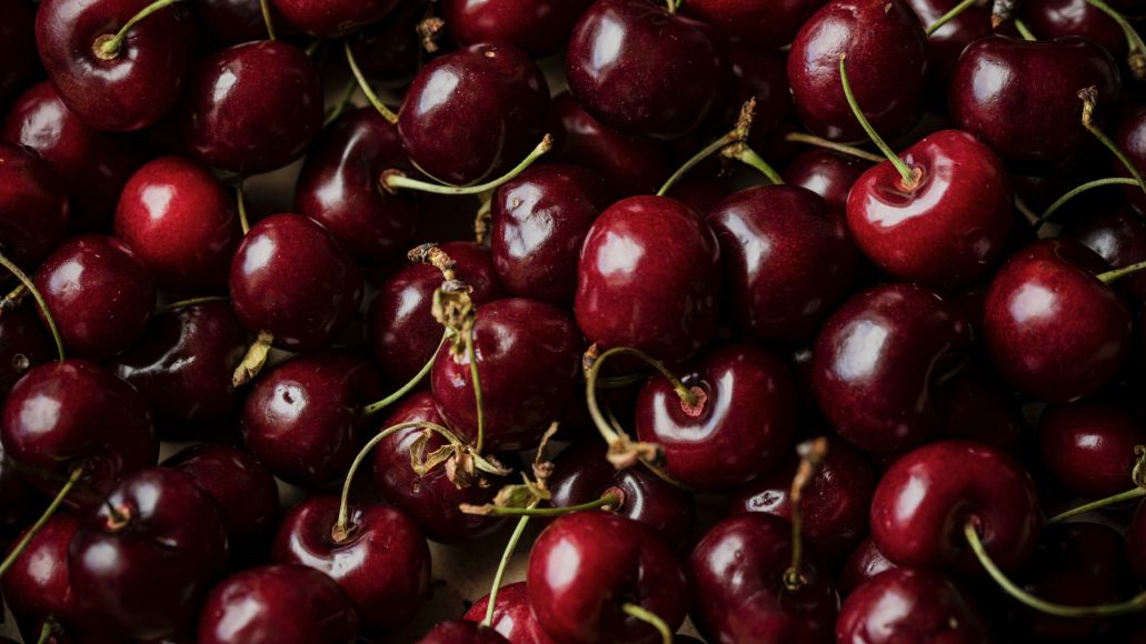 A close up of a pile of cherries